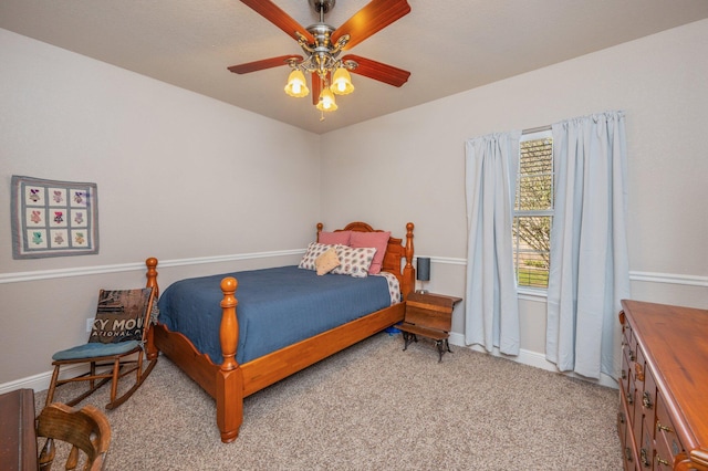 bedroom with light colored carpet, baseboards, and ceiling fan