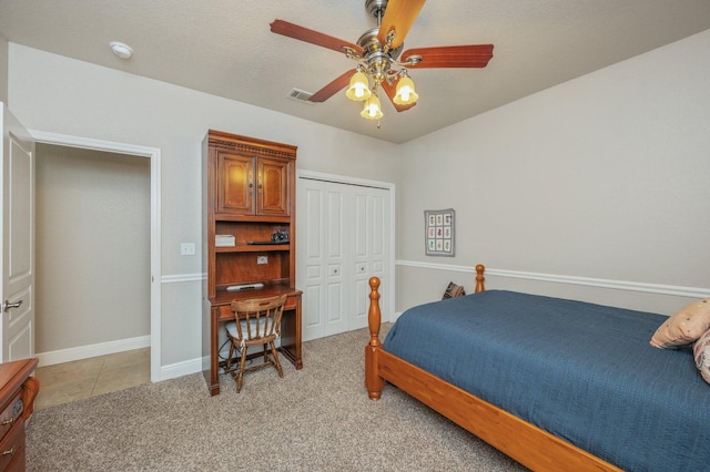 bedroom featuring visible vents, light carpet, a closet, baseboards, and ceiling fan