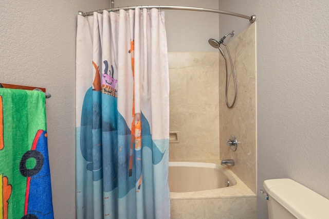 bathroom with toilet, shower / tub combo, and a textured wall