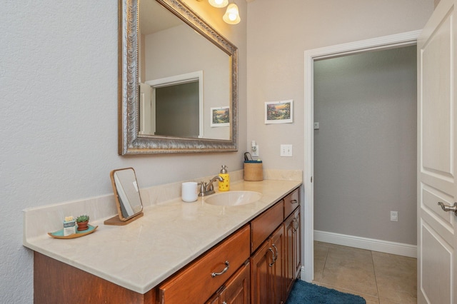 bathroom with vanity, tile patterned floors, and baseboards