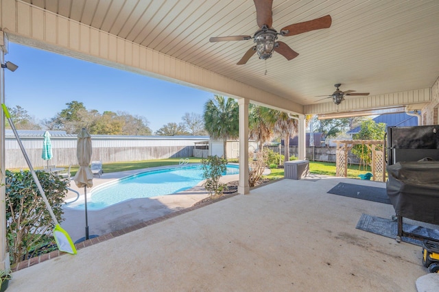 view of patio featuring a fenced in pool, a fenced backyard, and a ceiling fan