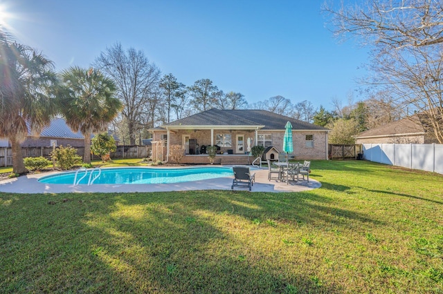 view of swimming pool featuring a patio, a fenced backyard, a fenced in pool, and a lawn