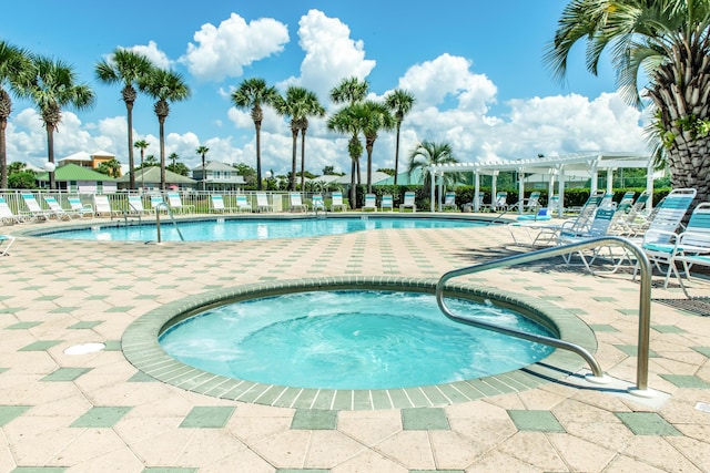 pool featuring a patio, fence, a hot tub, and a pergola