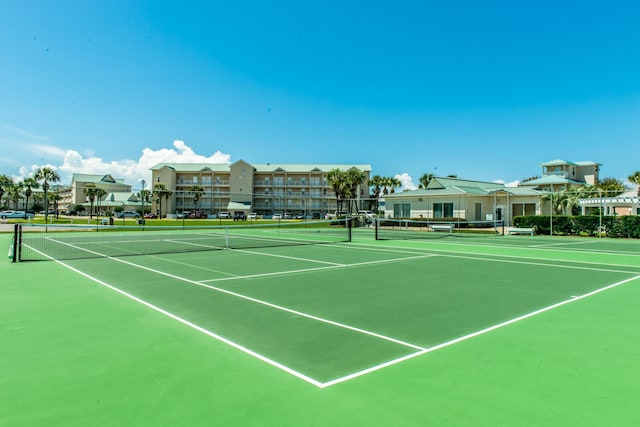 view of tennis court featuring fence