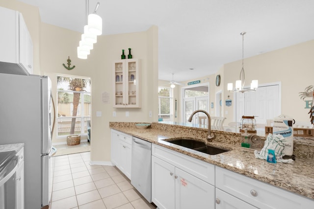 kitchen featuring a sink, plenty of natural light, dishwasher, and light tile patterned flooring