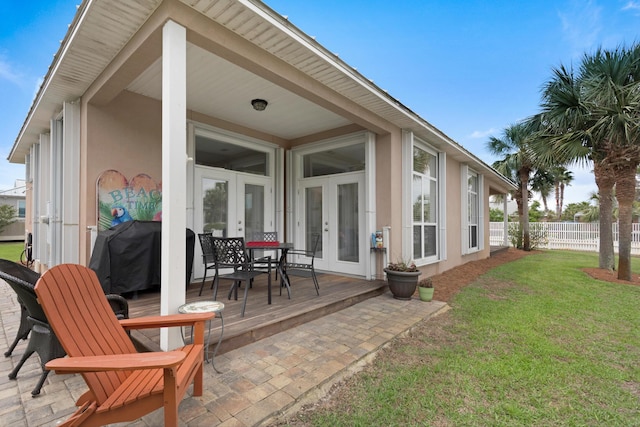 view of patio / terrace with fence, grilling area, and french doors