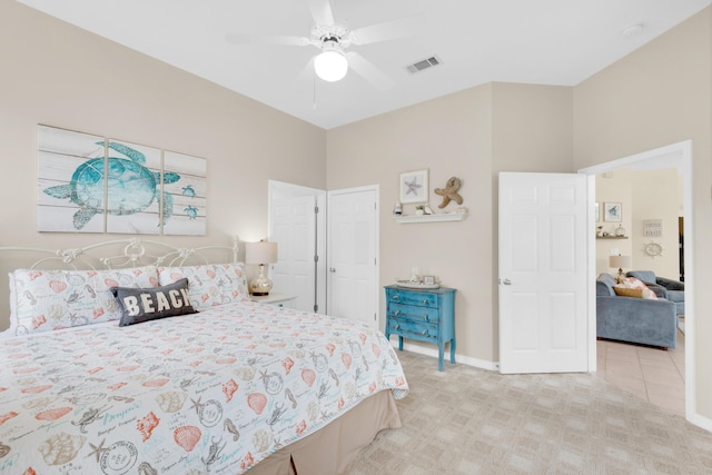 bedroom featuring a ceiling fan, light colored carpet, visible vents, and baseboards