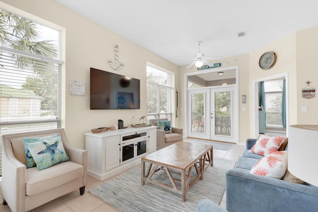 living area featuring ceiling fan, french doors, light tile patterned flooring, and visible vents