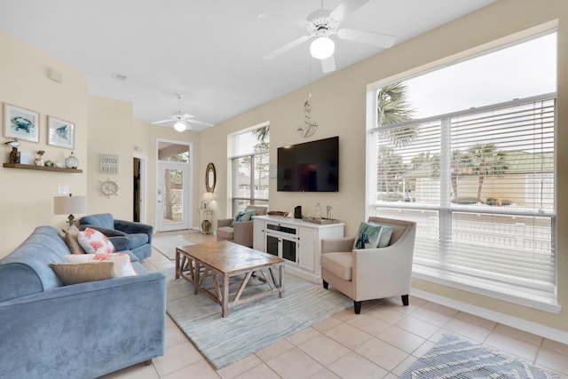 living room featuring a ceiling fan and light tile patterned floors