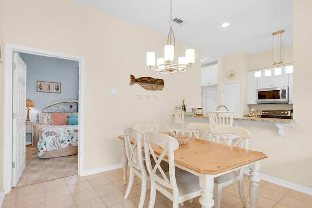 dining space with a chandelier, light tile patterned floors, visible vents, and baseboards