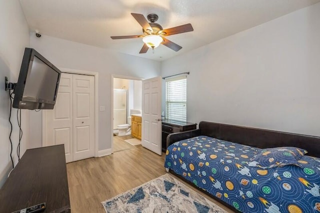 bedroom featuring a closet, ceiling fan, connected bathroom, and light wood-style floors