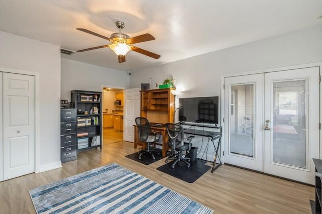 office space featuring french doors, baseboards, a ceiling fan, and wood finished floors