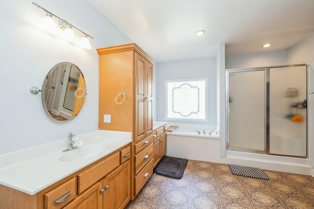 bathroom featuring recessed lighting, vanity, a bath, and a shower stall