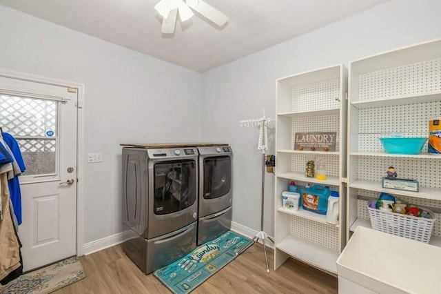 washroom featuring ceiling fan, laundry area, wood finished floors, and washing machine and clothes dryer