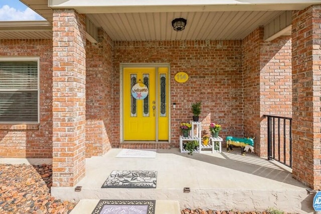 entrance to property featuring brick siding