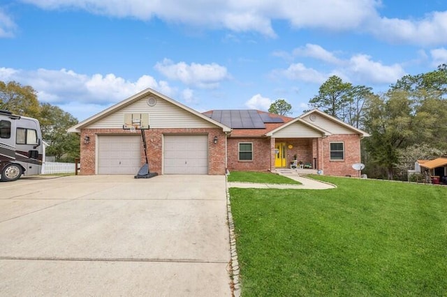 ranch-style house with brick siding, roof mounted solar panels, concrete driveway, and a front yard