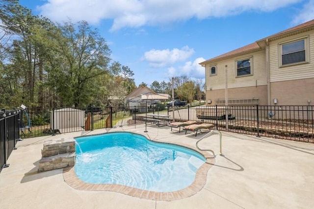 view of swimming pool with a patio area, a fenced in pool, and fence