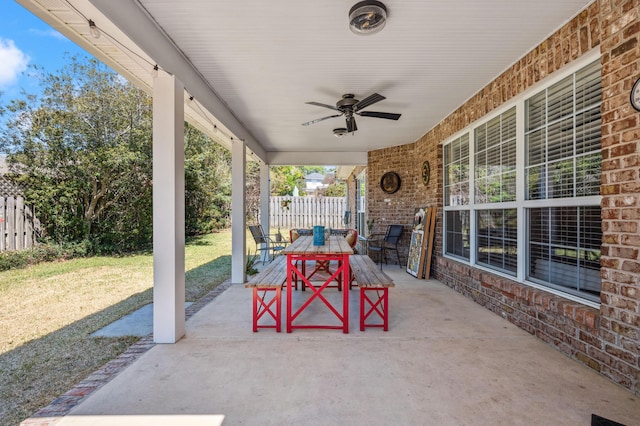 view of patio with outdoor dining space, a ceiling fan, and fence