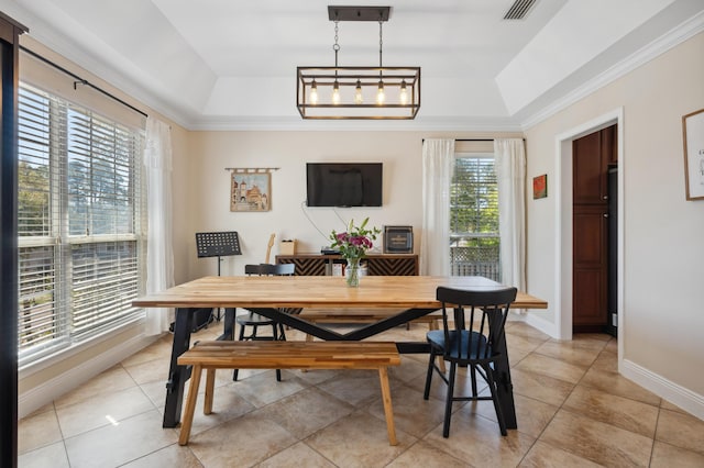 dining room featuring visible vents, crown molding, baseboards, light tile patterned floors, and a raised ceiling