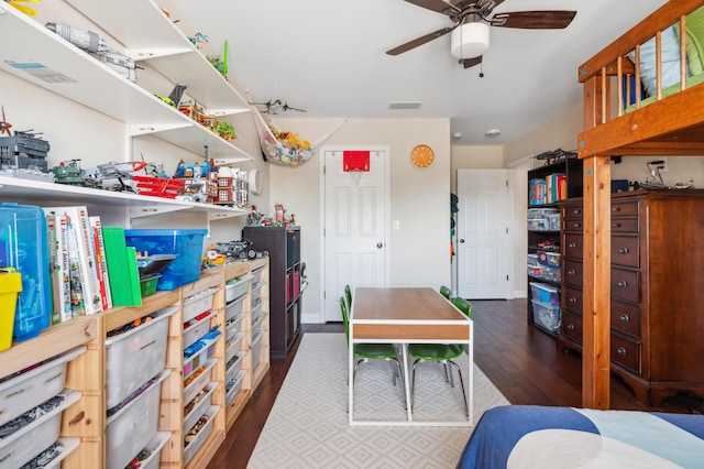 bedroom featuring visible vents, baseboards, and wood finished floors