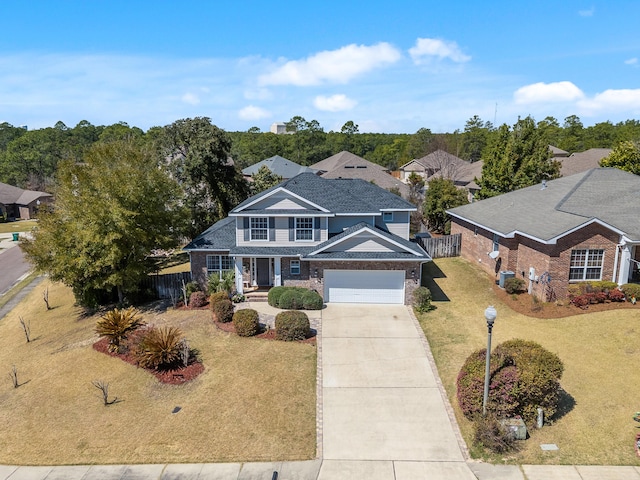 traditional-style home featuring brick siding, concrete driveway, a front yard, and fence