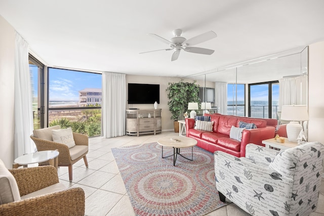 living room featuring floor to ceiling windows, light tile patterned floors, and ceiling fan