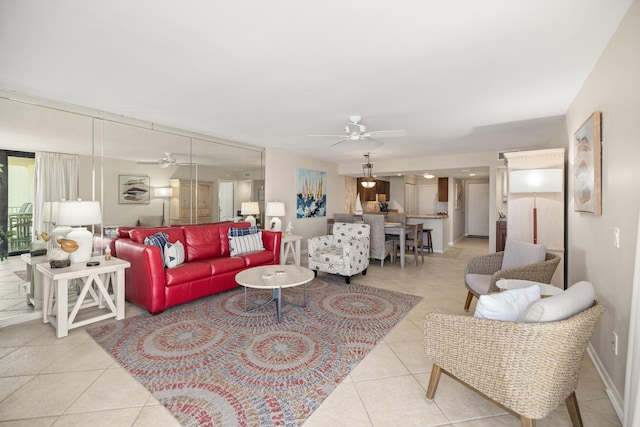 living room with light tile patterned floors, baseboards, and a ceiling fan