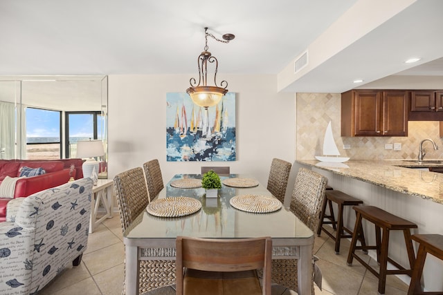 dining space with light tile patterned flooring and visible vents