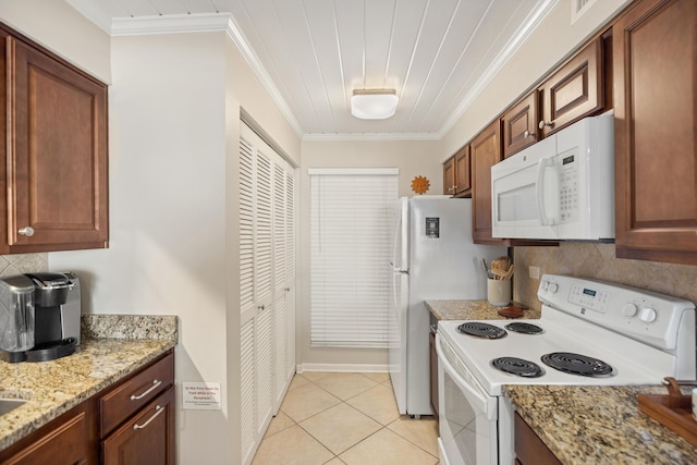 kitchen featuring light tile patterned flooring, decorative backsplash, white appliances, and crown molding