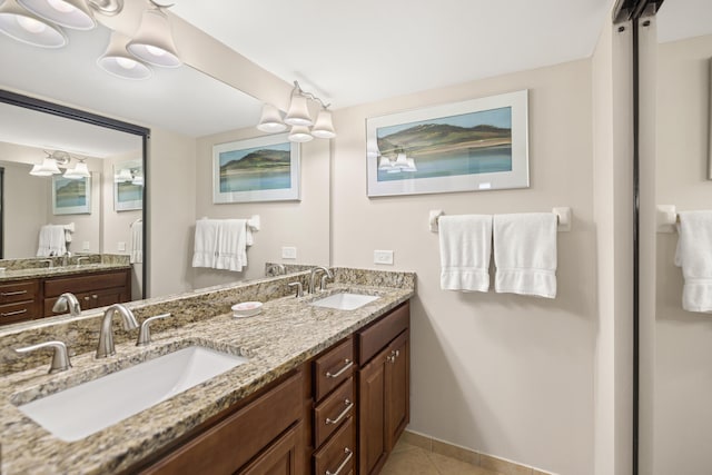 full bathroom featuring tile patterned floors, double vanity, and a sink