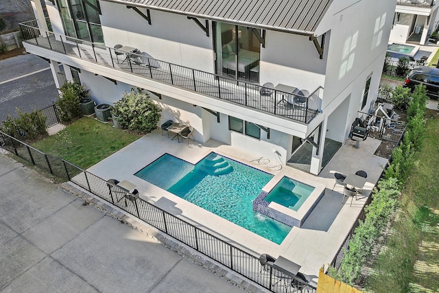 view of swimming pool with a patio, central AC unit, fence private yard, and a pool with connected hot tub