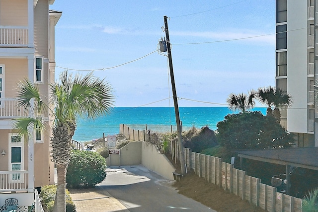 water view with a view of the beach and fence