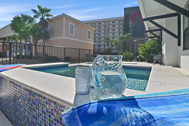 outdoor pool featuring a patio area and fence