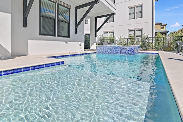 view of swimming pool with a fenced in pool and fence