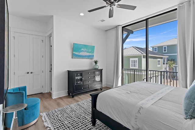 bedroom featuring wood finished floors, visible vents, baseboards, ceiling fan, and access to exterior