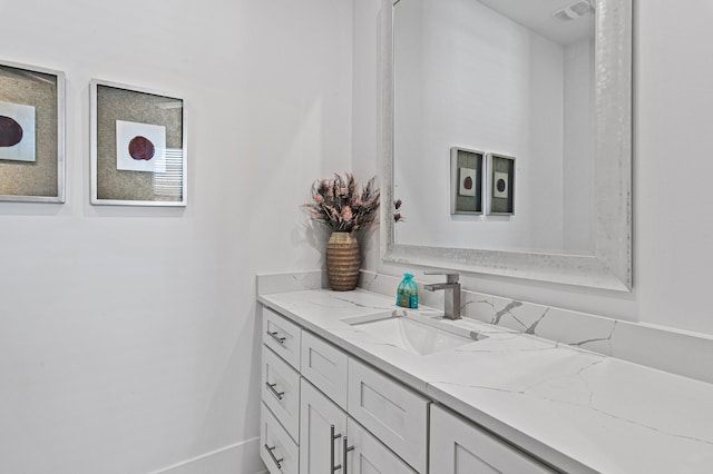 bathroom with visible vents, baseboards, and vanity