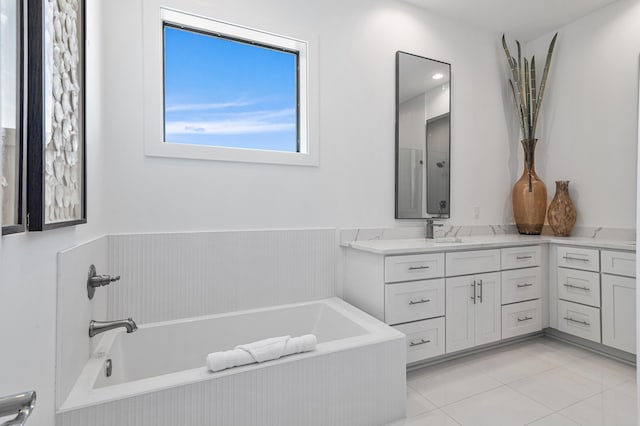 full bath with tile patterned flooring, vanity, and a garden tub