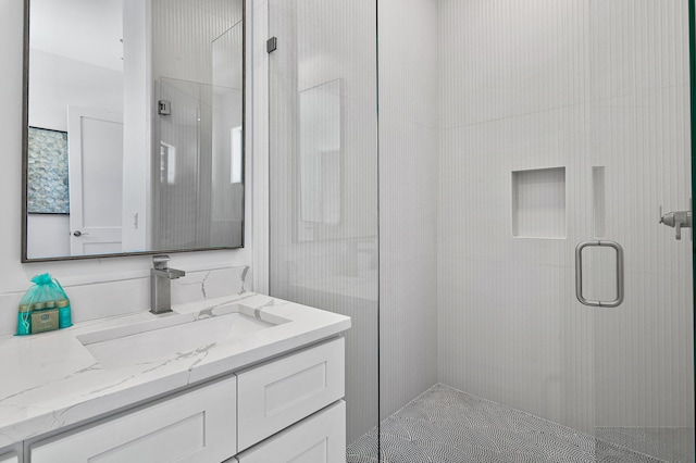 bathroom with a stall shower and vanity