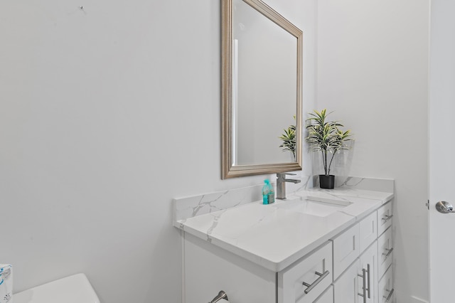 half bathroom featuring toilet and vanity