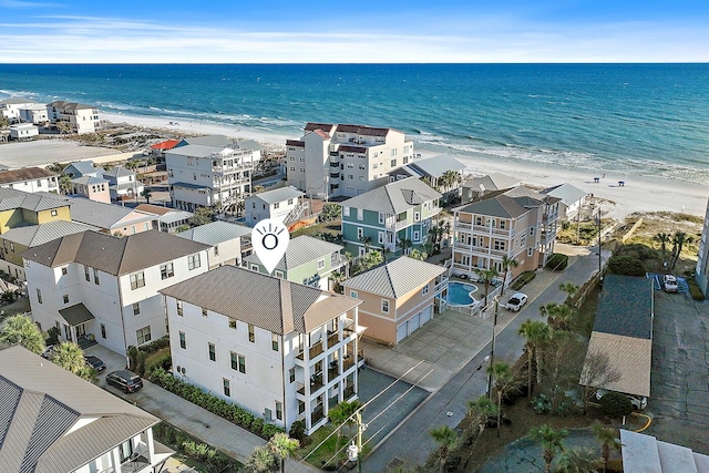 bird's eye view featuring a water view and a beach view