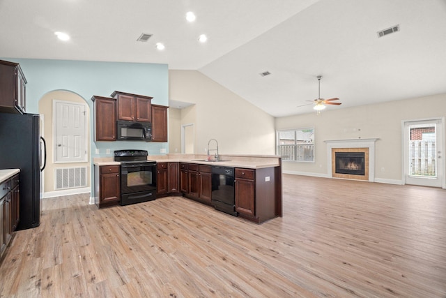 kitchen with visible vents, a peninsula, black appliances, and light countertops