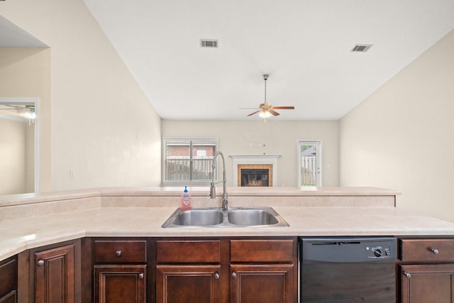 kitchen featuring visible vents, a tile fireplace, a sink, light countertops, and dishwasher