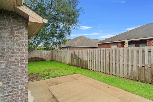 view of yard featuring a patio and a fenced backyard