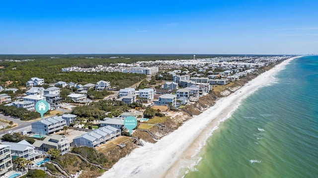 bird's eye view featuring a water view and a beach view