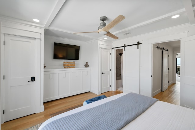 bedroom with visible vents, recessed lighting, ornamental molding, a barn door, and light wood-type flooring