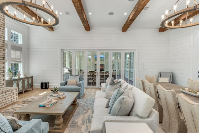 sunroom / solarium featuring beamed ceiling, a notable chandelier, french doors, and visible vents