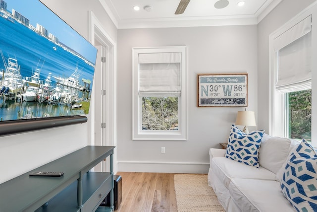 living area featuring recessed lighting, wood finished floors, baseboards, and ornamental molding