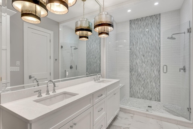 full bathroom featuring a stall shower, marble finish floor, and a sink