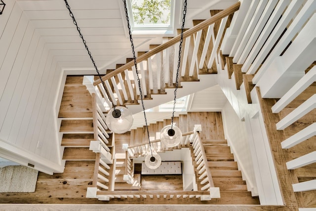 stairs featuring wood walls