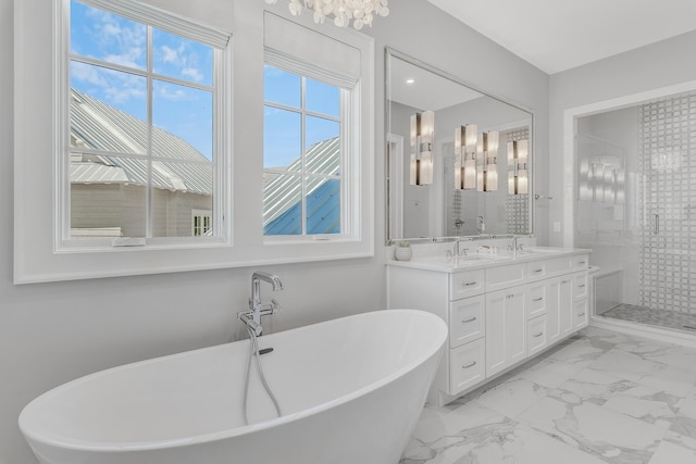 bathroom with a freestanding tub, marble finish floor, a sink, a shower stall, and double vanity